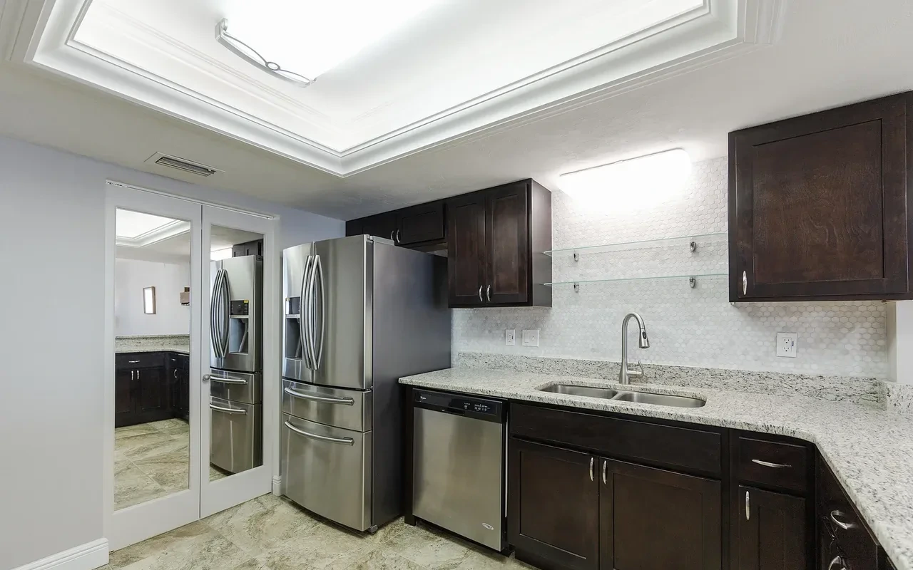 Renovated kitchen with espresso cabinets and granite