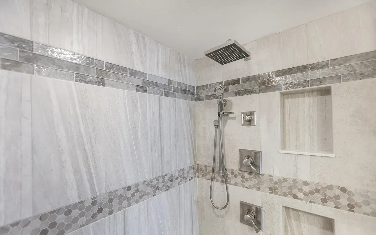 Primary shower with rain head and tile accents